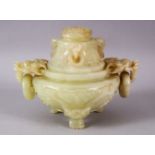 A CHINESE CARVED JADE TRIPD LIDDED CENSER, carved with lion dog handles and rings, stood upon