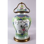 A CHINESE FAMILLE VERTE PORCELAIN VASE / LAMP, with panel decoration of birds in flora, green ground