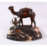 A GOOD TURKISH SPELTER FIGURE OF A CAMEL AND ATTENDANT, the attendant in prayer aside his camel,
