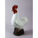 A CHINESE PORCELAIN FIGURE OF A COCKEREL, with carved feather decoration with a pale celadon