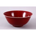 A CHINESE MING STYLE COPPER RED PORCELAIN BOWL, the base with a six character mark and label, 21.
