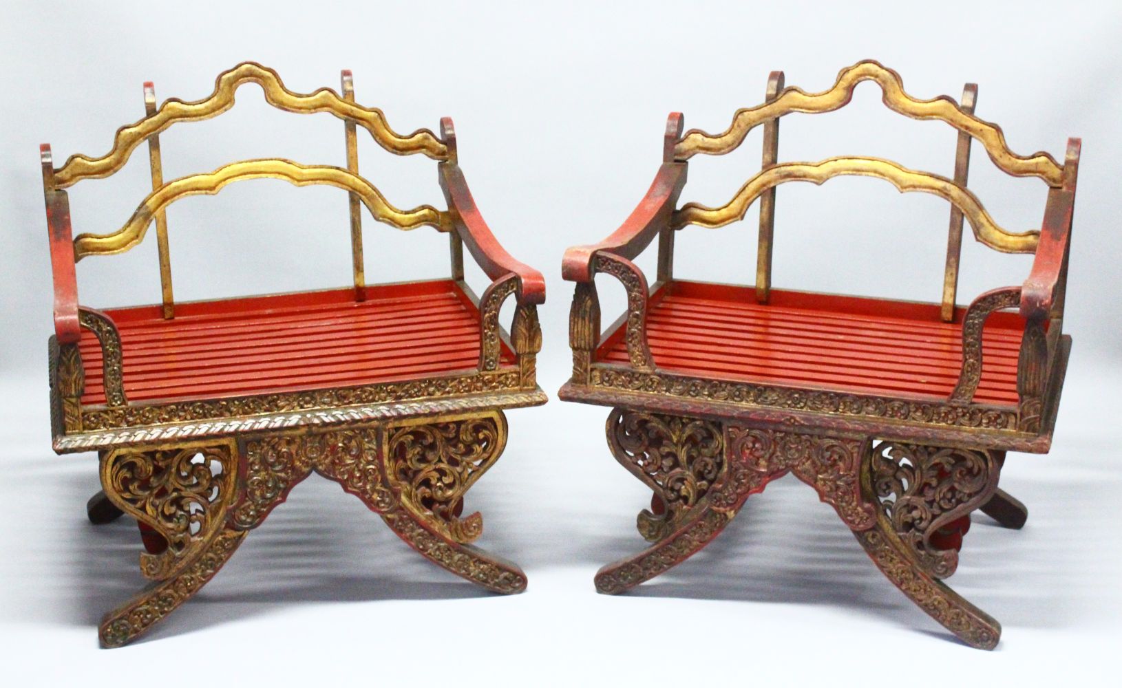 A PAIR OF 19TH/20TH CENTURY THAI CARVED HOWDAH ELEPHANT CHAIRS, profusely carved and pierced with