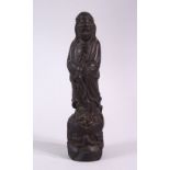 A SMALL CARVED WOOD FIGURE OF GUANYIN, 21cm high.