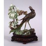 A CHINESE CARVED JADEITE FIGURE OF A PEACOCK & FLORA, the peacock stood upon a rocky outcrop ith