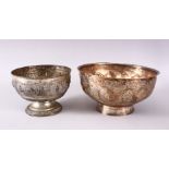TWO BURMESE WHITE METAL BOWLS, each with relief decoration, one with roundel's of figures, 16cm