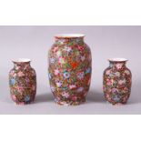 A GARNITURE OF THREE SMALL 19TH/20TH CENTURY CHINESE MILLIFLEUR VASES, the bodies decorated with the