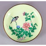 A CHINESE ENAMEL FLORAL DISH, the dish with a pale lime green ground depicting a bird seated in