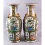 A LARGE PAIR OF 19TH CENTURY CHINESE CANTON FAMILLE ROSE VASES, decorated with larger panels of