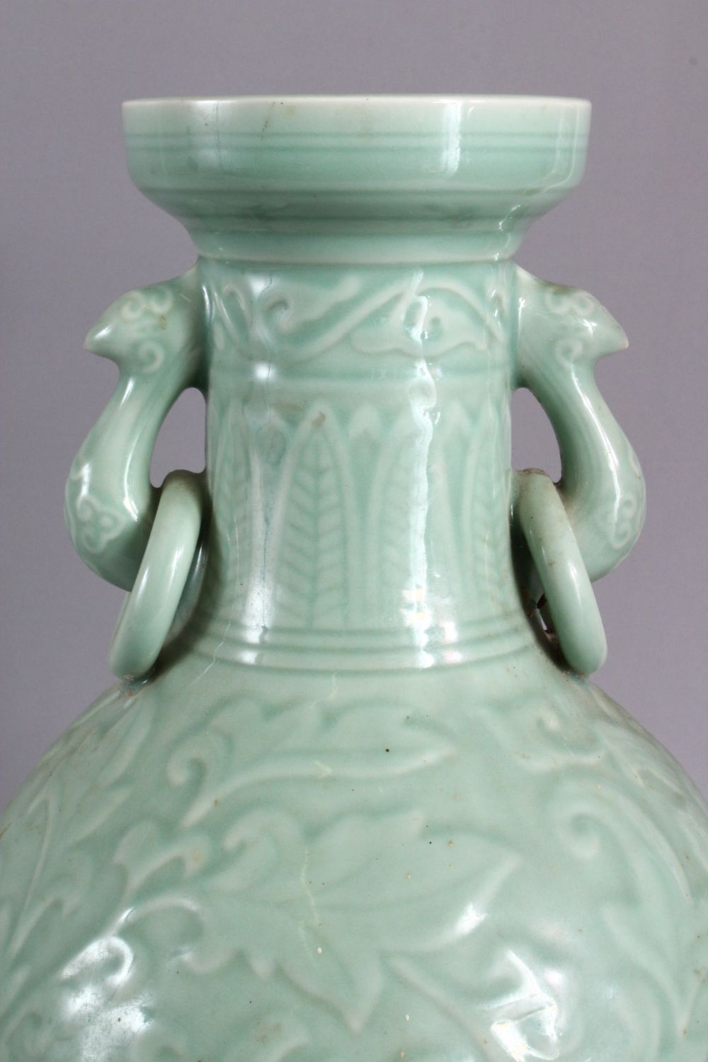 A LARGE CHINESE CELADON PORCELAIN TWIN HANDLE VASE, the body with carved floral decoration beneath a - Image 3 of 9