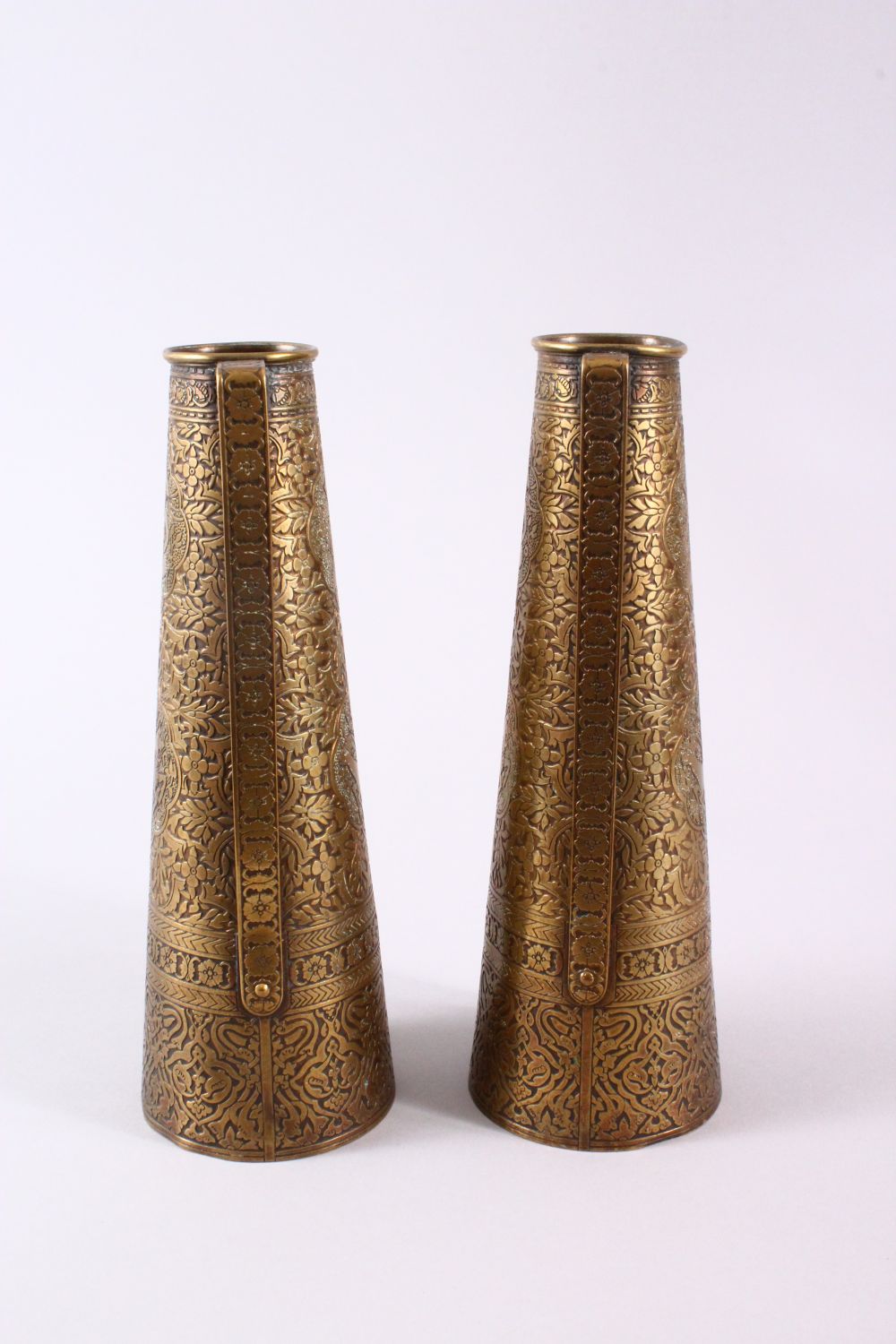 A PAIR OF PERSIAN BRASS ENGRAVED VASES, with twin handles, carved panels of figures and foliage, - Image 4 of 11