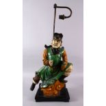 A CHINESE SANCAI GLAZED FIGURE OF A WARRIOR AS A LAMP, the figure fitted to a wooden base with light