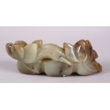 A CARVED CHINESE JADE LOTUS FORM STAND, carved with lotus emerging from the ground, 15cm.