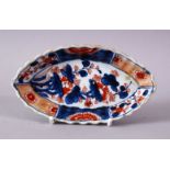 A 19TH CENTURY JAPANESE IMARI DECORATED SPOON TRAY, 15cm long.