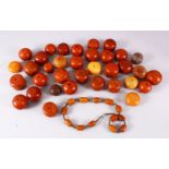 A LARGE LOT OF BAKELITE OR CHERRY AMBER STYLE CARVED BEADS, comprising 35 large beads and a necklace