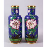 A PAIR OF CHINESE CLOISONNE BLUE GROUND VASES - each with a royal blue ground and native display