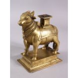 A 19TH CENTURY SOUTH INDIAN BRASS FIGURE OF NANDI BULL, 17cm high, 14cm long.