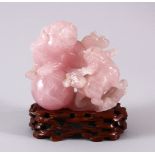 AN EARLY 20TH CENTURY CHINESE CARVED ROSE QUARTZ FIGURE OF LION DOGS, the two dogs playing with