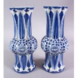 A PAIR OF CHINESE BLUE AND WHITE SLEEVE VASES, 27cm high.