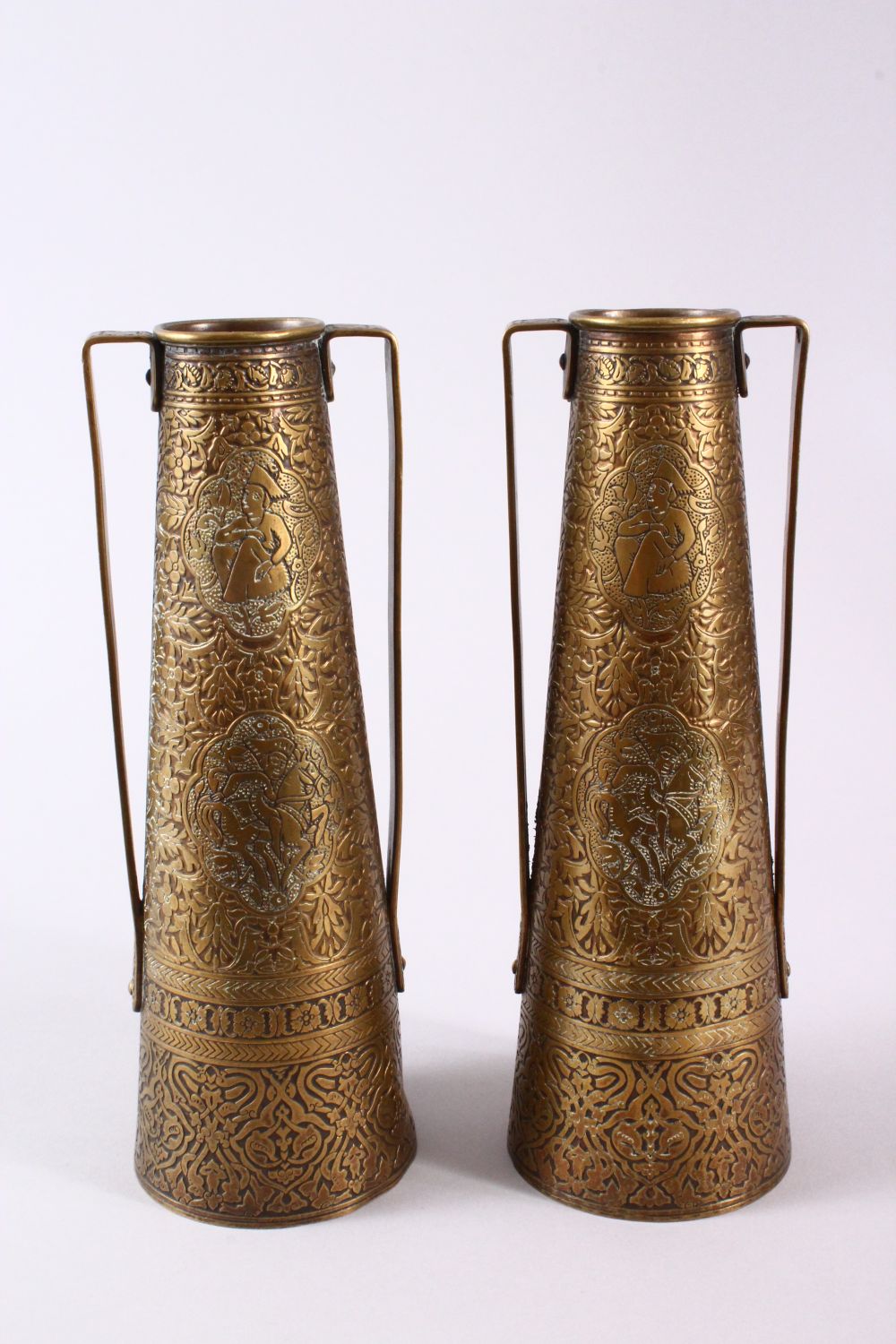 A PAIR OF PERSIAN BRASS ENGRAVED VASES, with twin handles, carved panels of figures and foliage, - Image 5 of 11