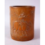 AN 18TH CENTURY CHINESE BAMBOO BRUSH POT, carved with a man riding an oxen with calligraphy, 15cm