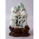 A CHINESE CARVED JADEITE LANDSCAPE STONE, carved depicting a native landscape with pine trees and an
