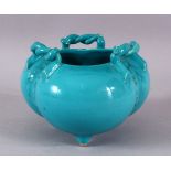 A CHINESE TURQUOISE GLAZED TRIPLE FOOT PORCELAIN CENSER, with twisted rope handles, 12cm