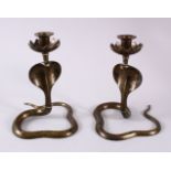 A PAIR OF INDIAN COBRA SNAKE FORMED CANDLE STICKS, the sticks in the form of cobras, with chased and