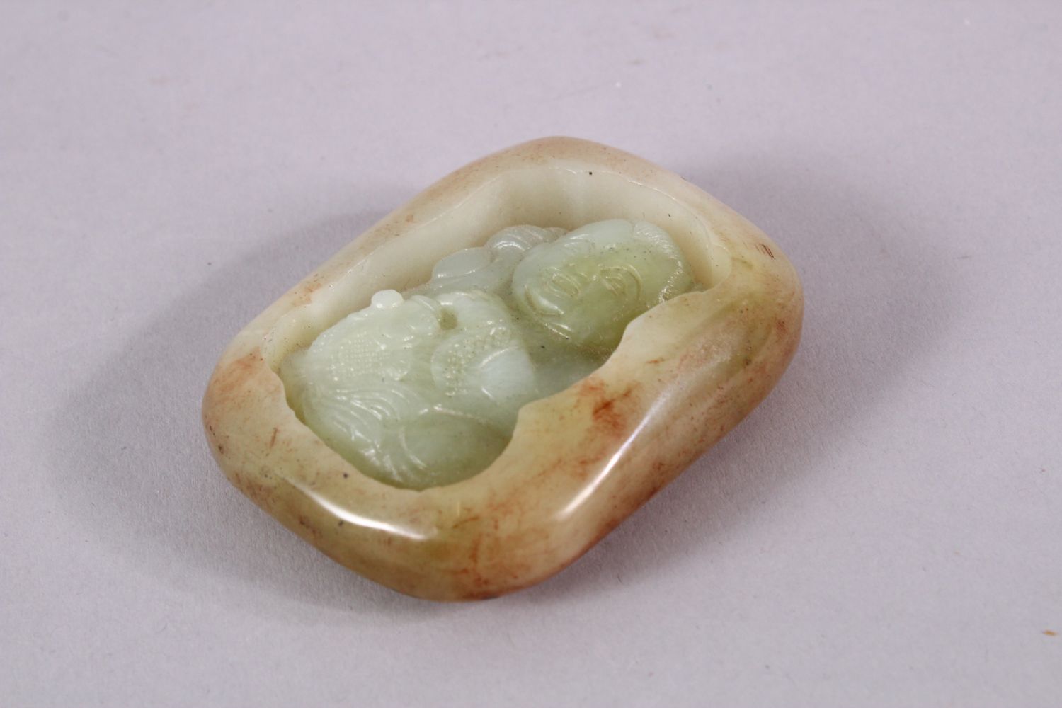 A CHINESE CARVED JADE PENDAND OF A BOY - the jade pebble carve din deep relief depicting a seated - Image 2 of 3