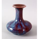 A CHINESE FLAMBE PORCELAIN VASE, with a graduated red - blue glaze, base unglazed, 11.5cm high