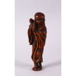 A JAPANESE EDO / MEIJI CARVED BOXWOOD NETSUKE OF A SENNIN, stood holding his staff, himotoshi formed