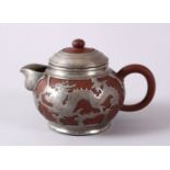 A CHINESE YIXING CLAY & WHITE METAL DRAGON TEAPOT, The body of the teapot encapsulated with a carved