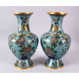 A PAIR OF CHINESE CLOISONNE BLUE GROUND VASES, each with a pale blue ground and native views of