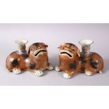 A PAIR OF CHINESE 18TH / 19TH CENTURY FAMILLE ROSE DOG FORMED CANDLESTICKS, with canton decorated