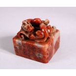 A CHINESE CARVED SOAPSTONE SEAL, carved with chilong and calligraphy, 5cm