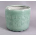 A CHINESE CELADON KEY PATTERN TRIPLE FOOT PLANTER, the body carved with celadon key and chilong