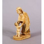 A RARE EARLY 19TH CENTURY INDIAN CARVED IVORY FIGURE of a Parsi woman and child, 5.5cm