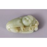 A CHINESE CARVED JADE FIGURE / PENDANT OF BUDDHA, in a recumbent position holding a tied double