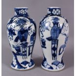 A PAIR OF 19TH CENTURY CHINESE BLUE AND WHITE PRUNUS VASES, painted with precious objects, four