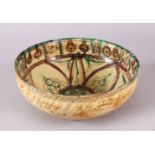 A GOOD IRAN STYLE POTTERY BOWL, decorated with green & biscuit grounds, with floral motif