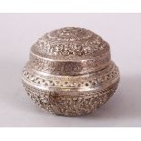 A SMALL INDIAN CIRCULAR WHITE METAL BOX & COVER, possibly silver, with moulded floral decoration,
