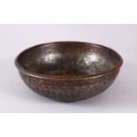A UNUSUAL ISLAMIC TINNED HAMMERED COPPER CALLIGRAPHIC BOWL, decorated with interior & exterior bands