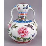 A CHINESE FAMILLE ROSE PORCELAIN TWIN HANDLE VASE, The body decorated with butterfly and flora,