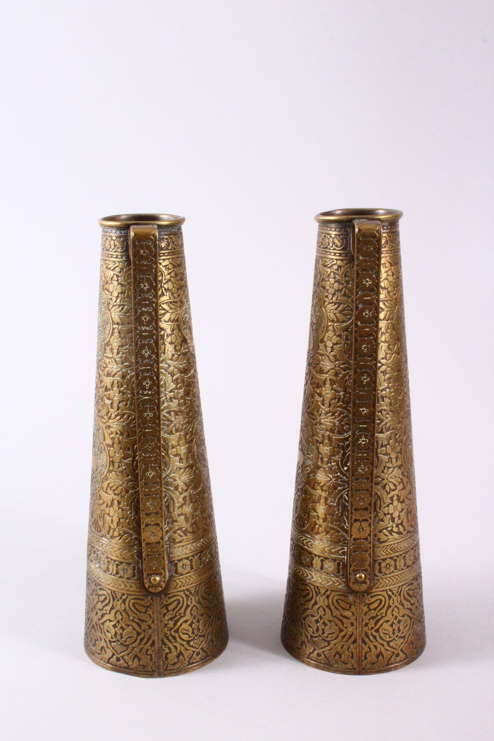 A PAIR OF PERSIAN BRASS ENGRAVED VASES, with twin handles, carved panels of figures and foliage, - Image 8 of 11