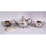 A VERY GOOD CHINESE THREE PIECE SILVER TEA SET, decorated with prunus and birds in relief, with