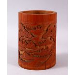 A CHINESE CARVED BAMBOO BRUSH POT, carved in canton style with figures in landscapes and temples,