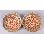A FINE PAIR OF 19TH CENTURY CHINESE IRON RED & GILT RETICULATED PLATES, each plate with iron red