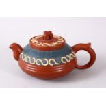A CHINESE YIXING CLAY TEAPOT, with moulded and poly chrome decoration, lid and base with impressed