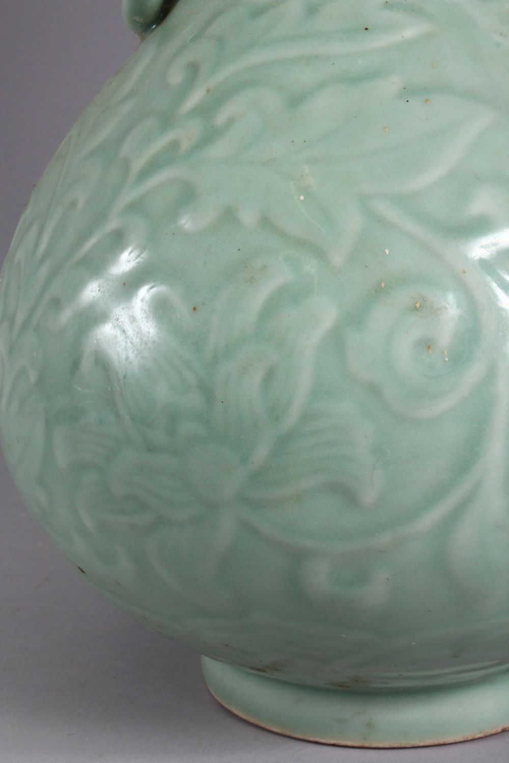 A LARGE CHINESE CELADON PORCELAIN TWIN HANDLE VASE, the body with carved floral decoration beneath a - Image 2 of 9
