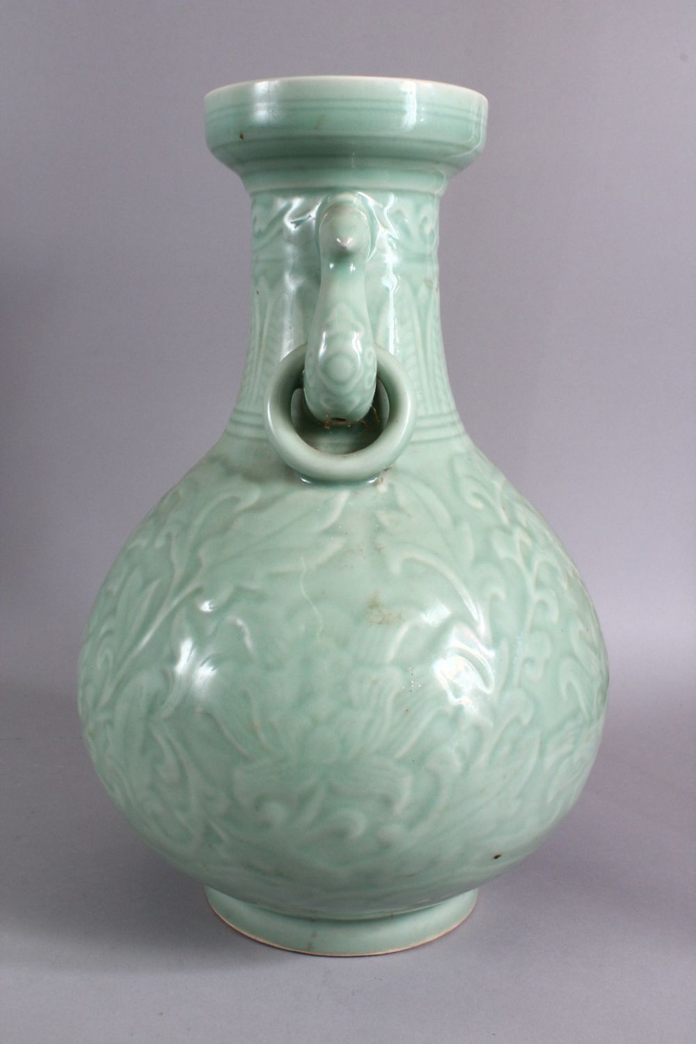 A LARGE CHINESE CELADON PORCELAIN TWIN HANDLE VASE, the body with carved floral decoration beneath a - Image 4 of 9