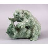 A CHINESE CARVED GREEN HARD STONE MODEL OF TWO PLAYING BEARS, 14cm high x 18cm wide.